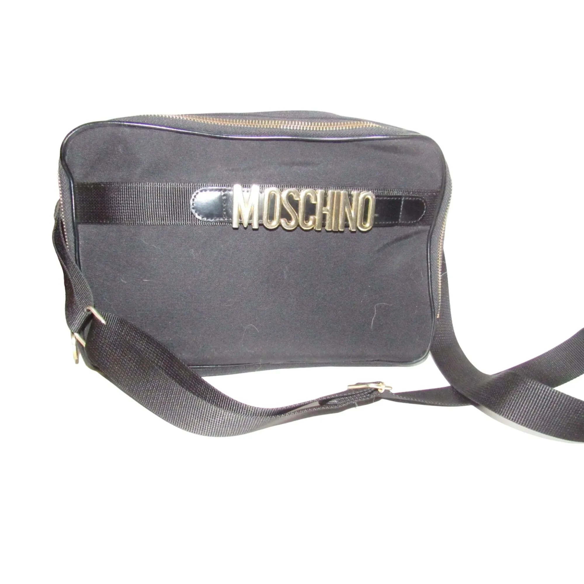 Moschino, black canvas & leather, cross body with a zip top, bold, gold, MOSCHINO letter accents, & a long strap with snaps on both sides